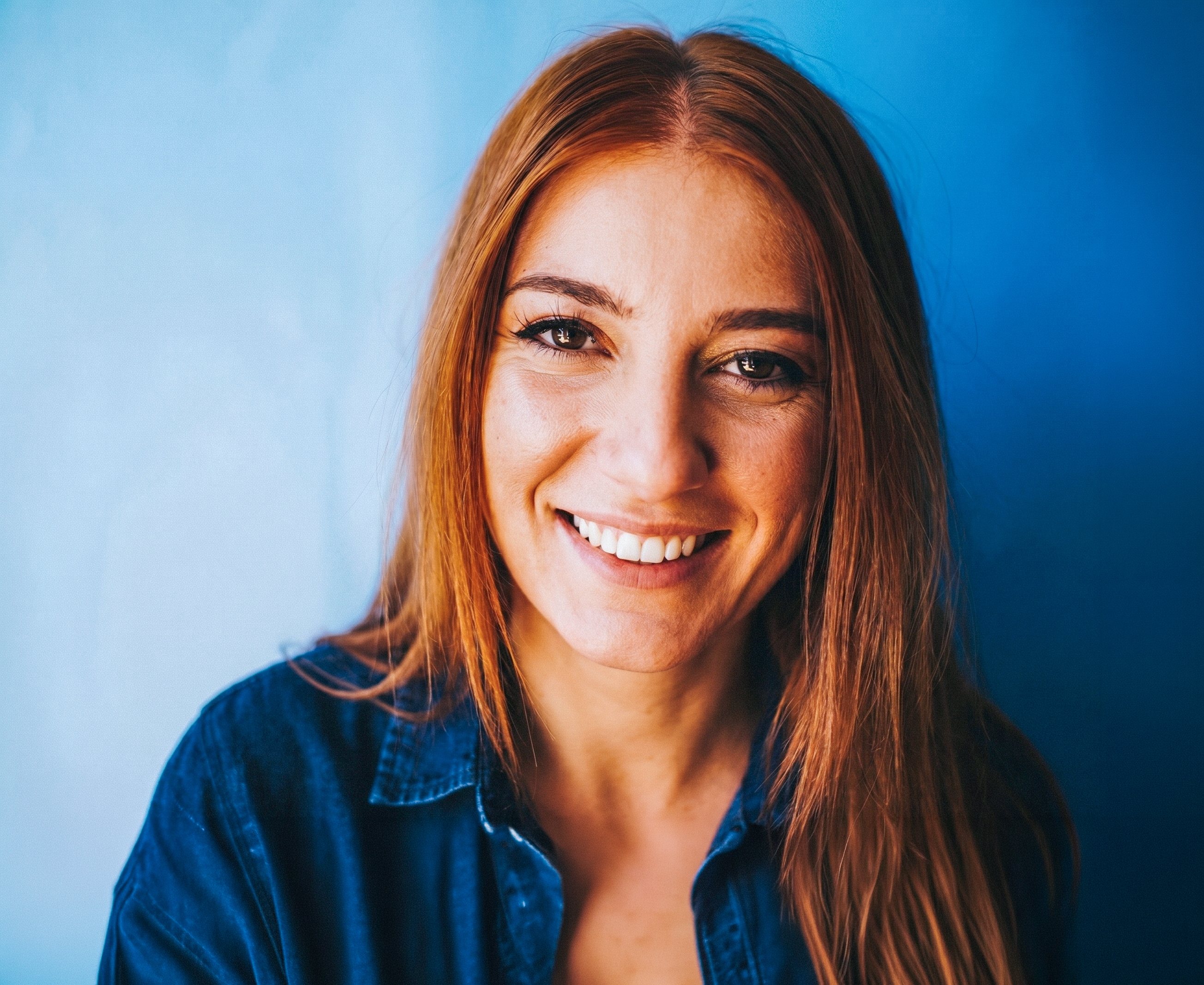 A smiling woman with red hair